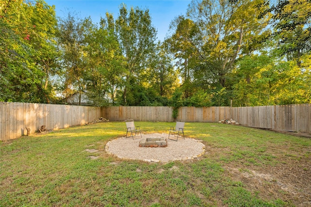 view of yard with an outdoor fire pit and a fenced backyard