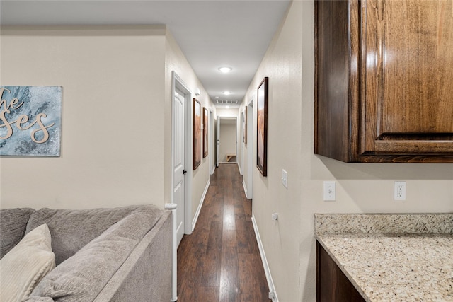 hall featuring baseboards and dark wood finished floors