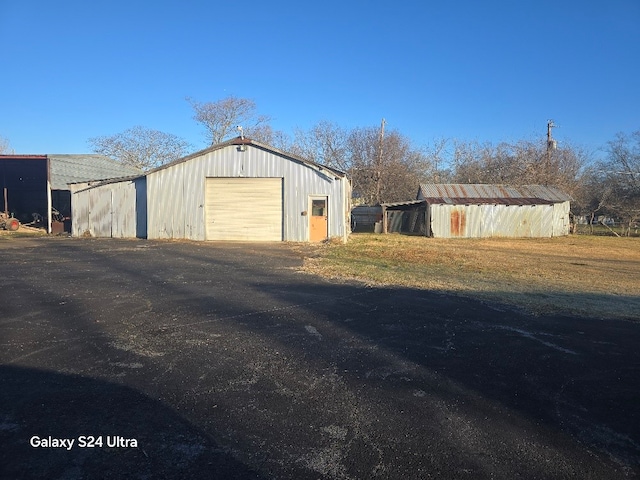 detached garage featuring driveway