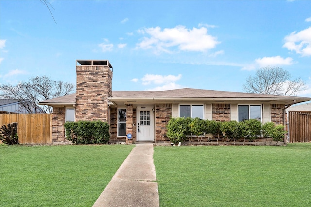 ranch-style home featuring brick siding, a front yard, and fence