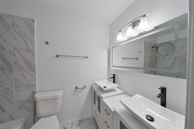 bathroom featuring toilet, marble finish floor, a shower, and a sink