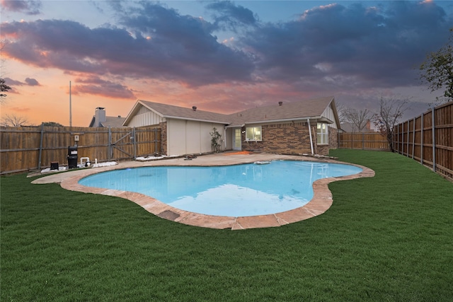 view of swimming pool with a patio area, a fenced backyard, a fenced in pool, and a lawn