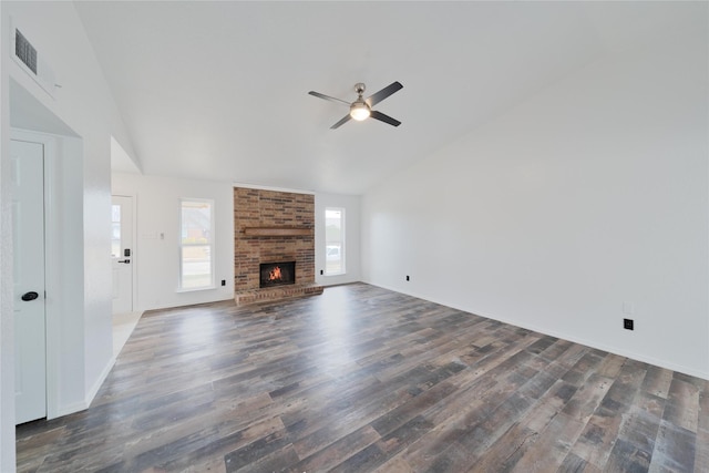 unfurnished living room with visible vents, lofted ceiling, ceiling fan, wood finished floors, and a fireplace