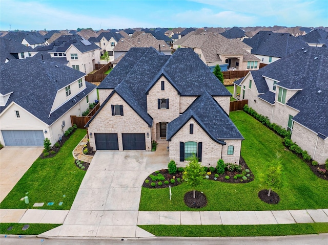 2310 Red Cedar Trl, Prosper, TX 75078 - french country inspired facade with a residential view, a shingled roof, driveway, brick siding, and stone siding
