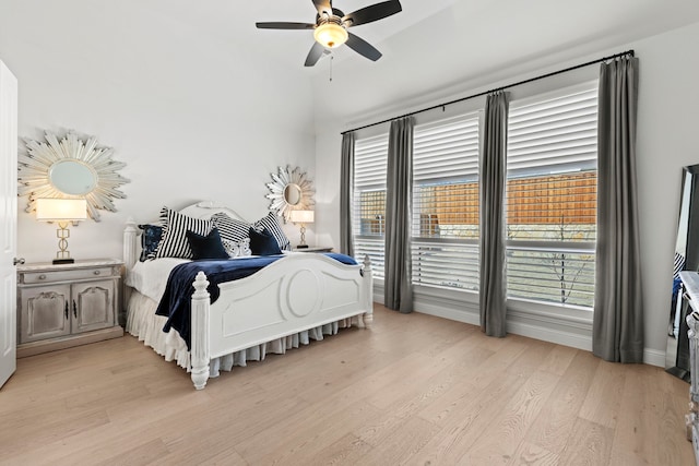 bedroom with a ceiling fan and light wood-type flooring