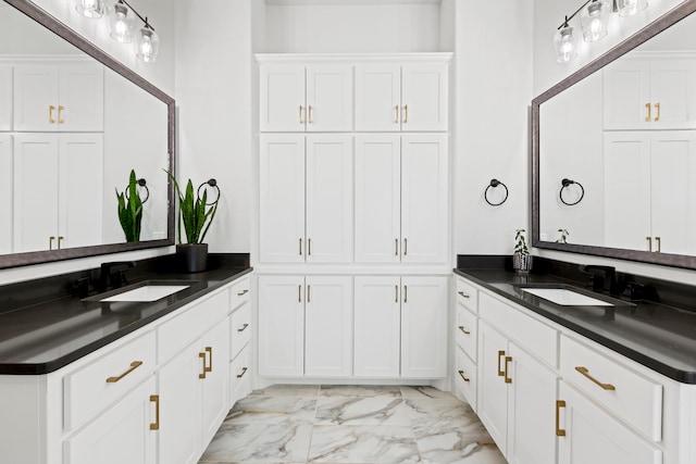 bathroom with marble finish floor and a sink