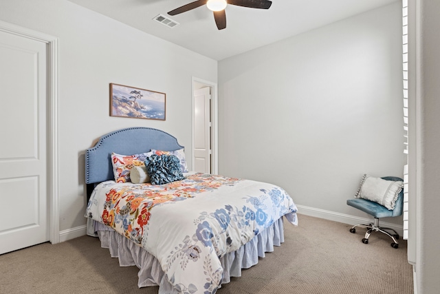 carpeted bedroom featuring baseboards, visible vents, and a ceiling fan