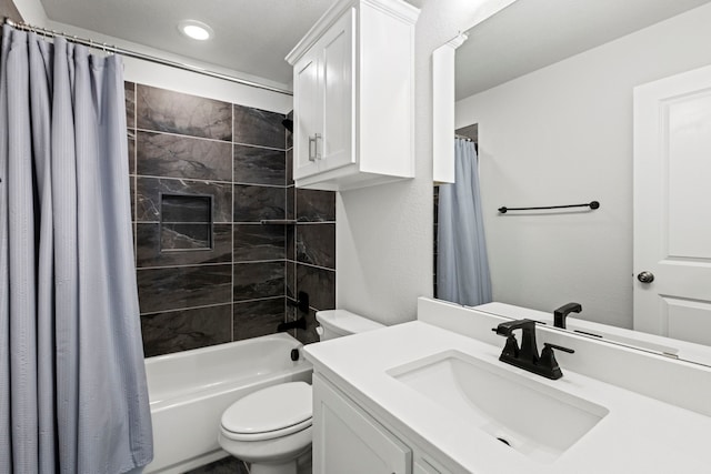 bathroom with toilet, shower / bathtub combination with curtain, and vanity