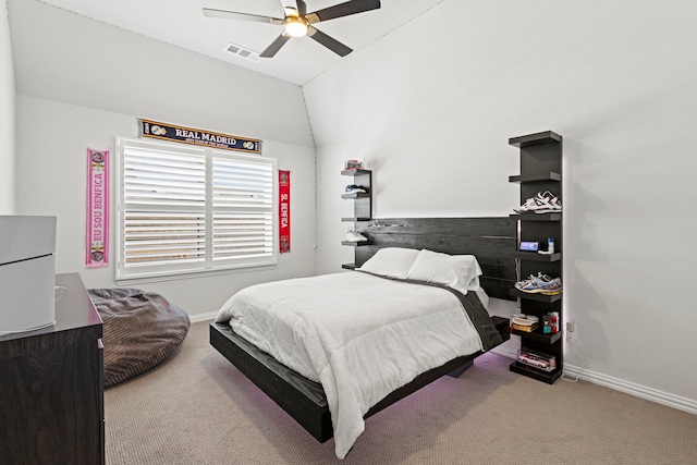 carpeted bedroom featuring baseboards, visible vents, vaulted ceiling, and a ceiling fan