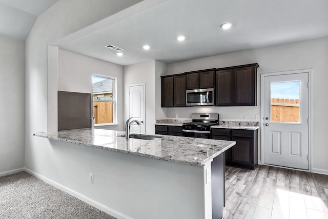 kitchen with appliances with stainless steel finishes, a sink, visible vents, and a healthy amount of sunlight