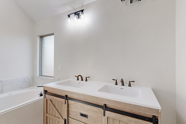 bathroom featuring double vanity, a sink, and a bath