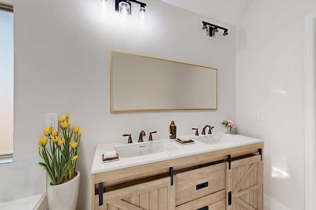 full bath featuring double vanity and a sink