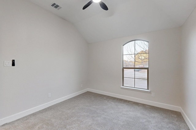 unfurnished room featuring visible vents, baseboards, a ceiling fan, lofted ceiling, and carpet