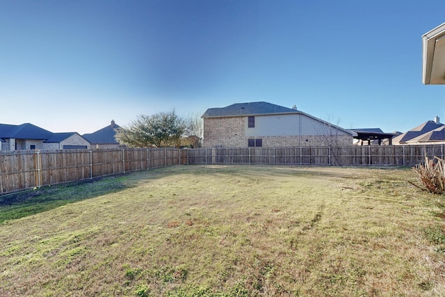 view of yard with a fenced backyard