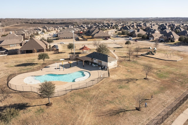 pool with a patio area, a residential view, and fence