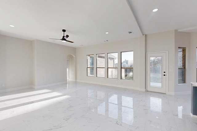 empty room featuring recessed lighting, marble finish floor, and baseboards