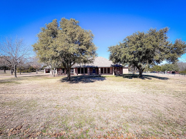 view of front of home with a front lawn and brick siding