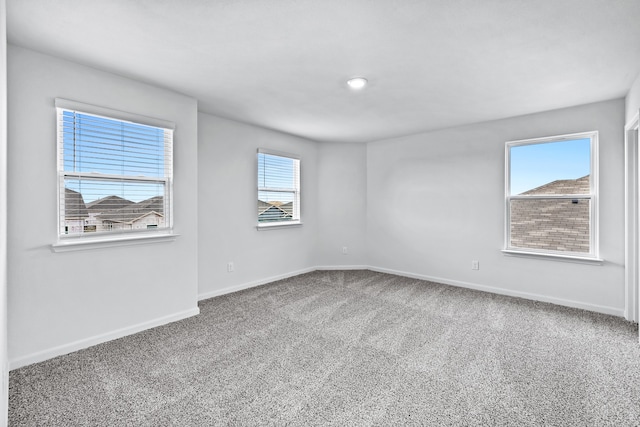 empty room with carpet flooring and baseboards