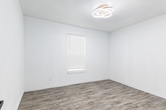 unfurnished room with light wood-style flooring and baseboards