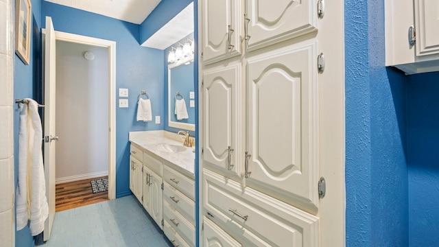 bathroom featuring baseboards and vanity