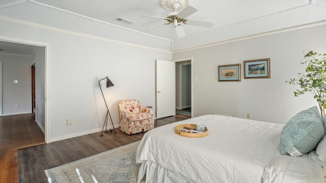 bedroom featuring ceiling fan, visible vents, baseboards, ornamental molding, and dark wood finished floors