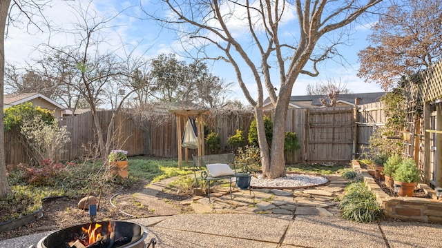 view of patio with an outdoor fire pit and a fenced backyard