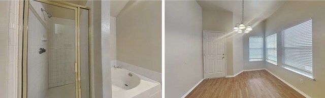 bathroom with a garden tub, a shower stall, and wood finished floors