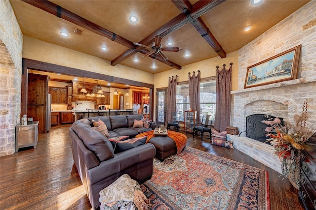 living area featuring a fireplace, visible vents, dark wood-style flooring, and beamed ceiling