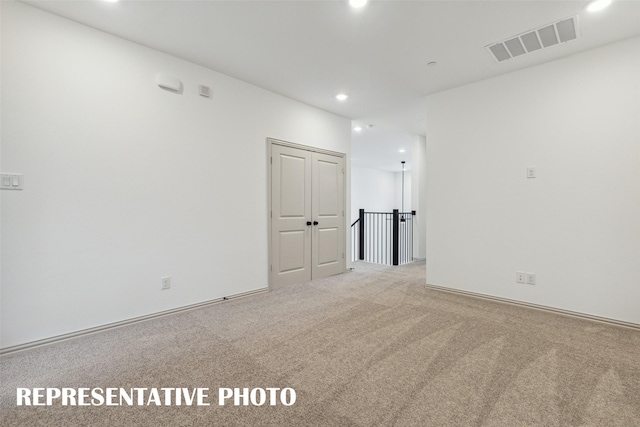 unfurnished room with recessed lighting, visible vents, and light colored carpet