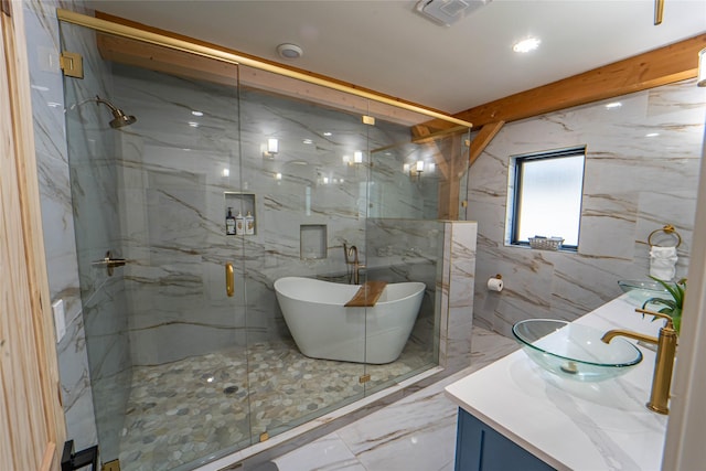 full bath featuring tile walls, vanity, marble finish floor, a marble finish shower, and visible vents