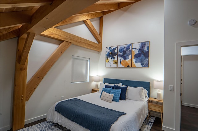 bedroom with wood finished floors and baseboards