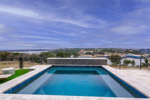 outdoor pool featuring fence and a patio area