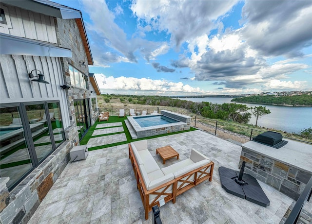 view of patio with fence, a water view, and a jacuzzi