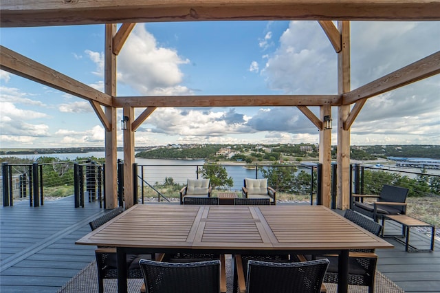 wooden deck featuring outdoor dining space and a water view