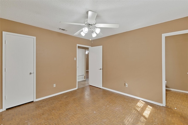 unfurnished bedroom with visible vents, baseboards, ceiling fan, and a textured ceiling