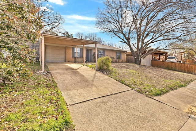 view of front of property with a garage, fence, concrete driveway, and brick siding