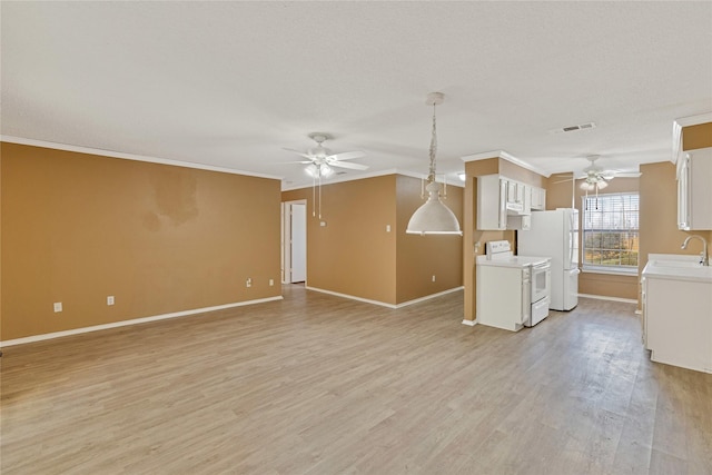 unfurnished living room with ceiling fan, ornamental molding, light wood-type flooring, and visible vents