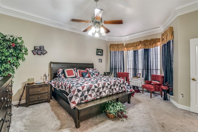 bedroom with crown molding, baseboards, and carpet flooring