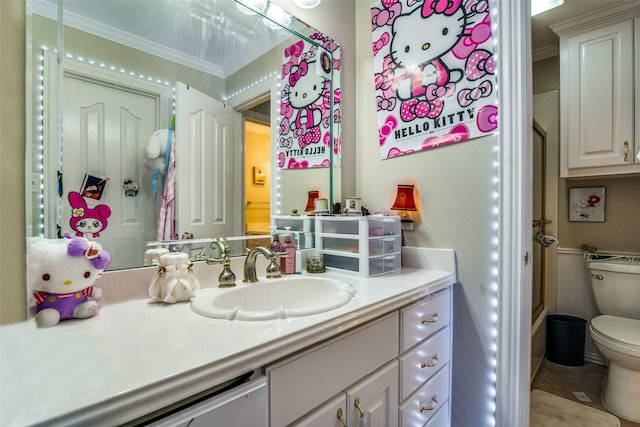 bathroom featuring toilet, crown molding, and vanity