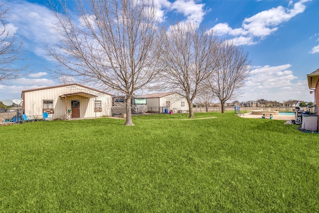 view of yard with a fenced backyard, a fenced in pool, and an outdoor structure