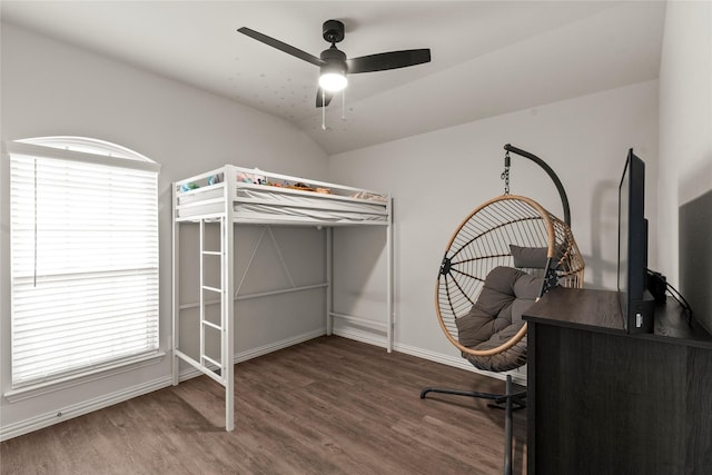 bedroom with lofted ceiling, wood finished floors, a ceiling fan, and baseboards