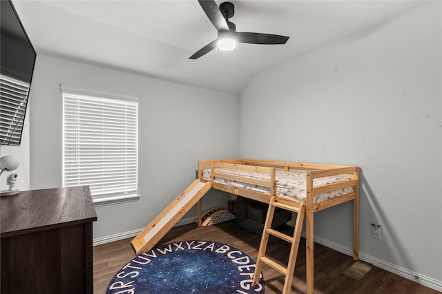 bedroom featuring lofted ceiling, dark wood finished floors, a ceiling fan, and baseboards