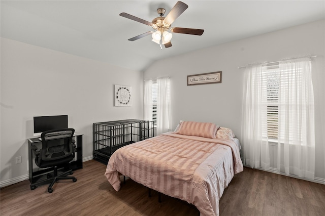 bedroom with dark wood-style floors, ceiling fan, lofted ceiling, and baseboards