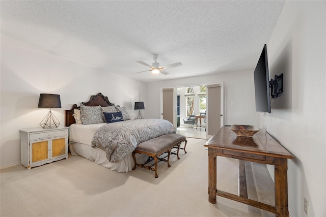 bedroom featuring carpet, a ceiling fan, and a textured ceiling