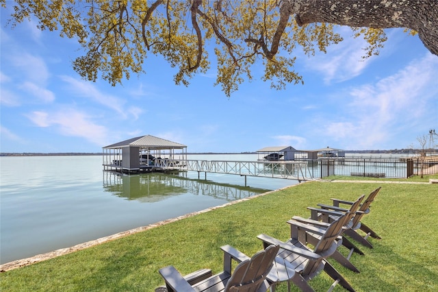 dock area featuring a yard and a water view