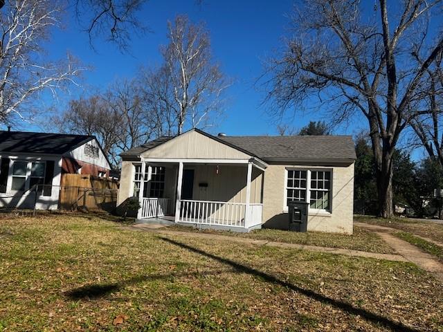 back of house featuring a porch and a lawn