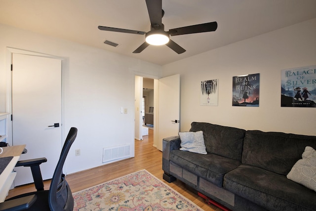 office featuring light wood-type flooring, ceiling fan, and visible vents