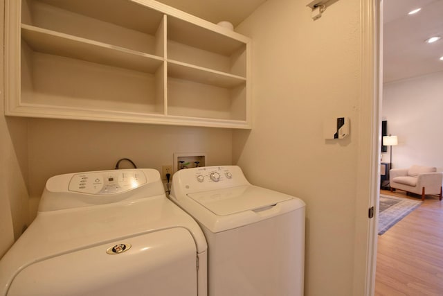 washroom featuring independent washer and dryer, laundry area, wood finished floors, and recessed lighting