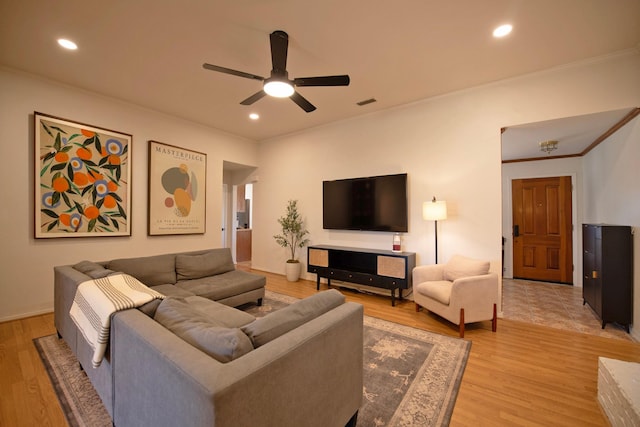 living area with ornamental molding, light wood-type flooring, a ceiling fan, and recessed lighting