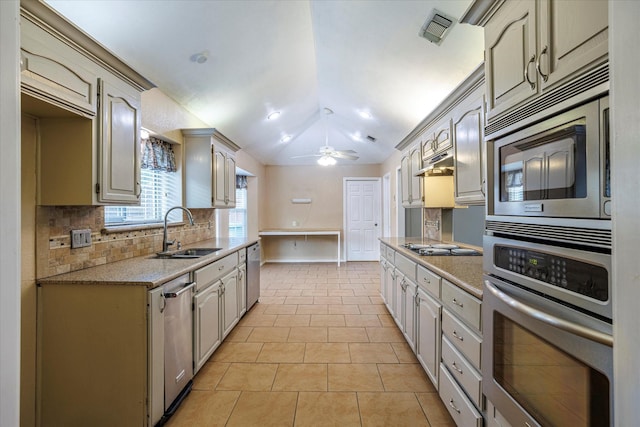 kitchen with light tile patterned floors, visible vents, appliances with stainless steel finishes, vaulted ceiling, and a sink